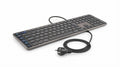 Clavier connecté noir et gris métal avec touches de raccourci dédiées IA, câble tressé robuste et prise européenne.